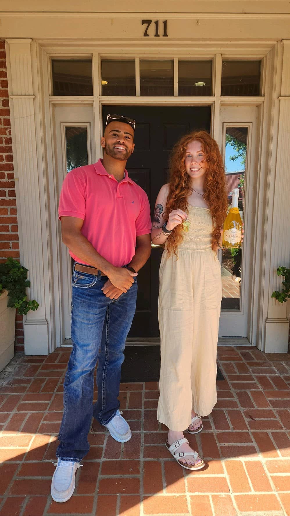 Madison Burke and client celebrating in front of a home
