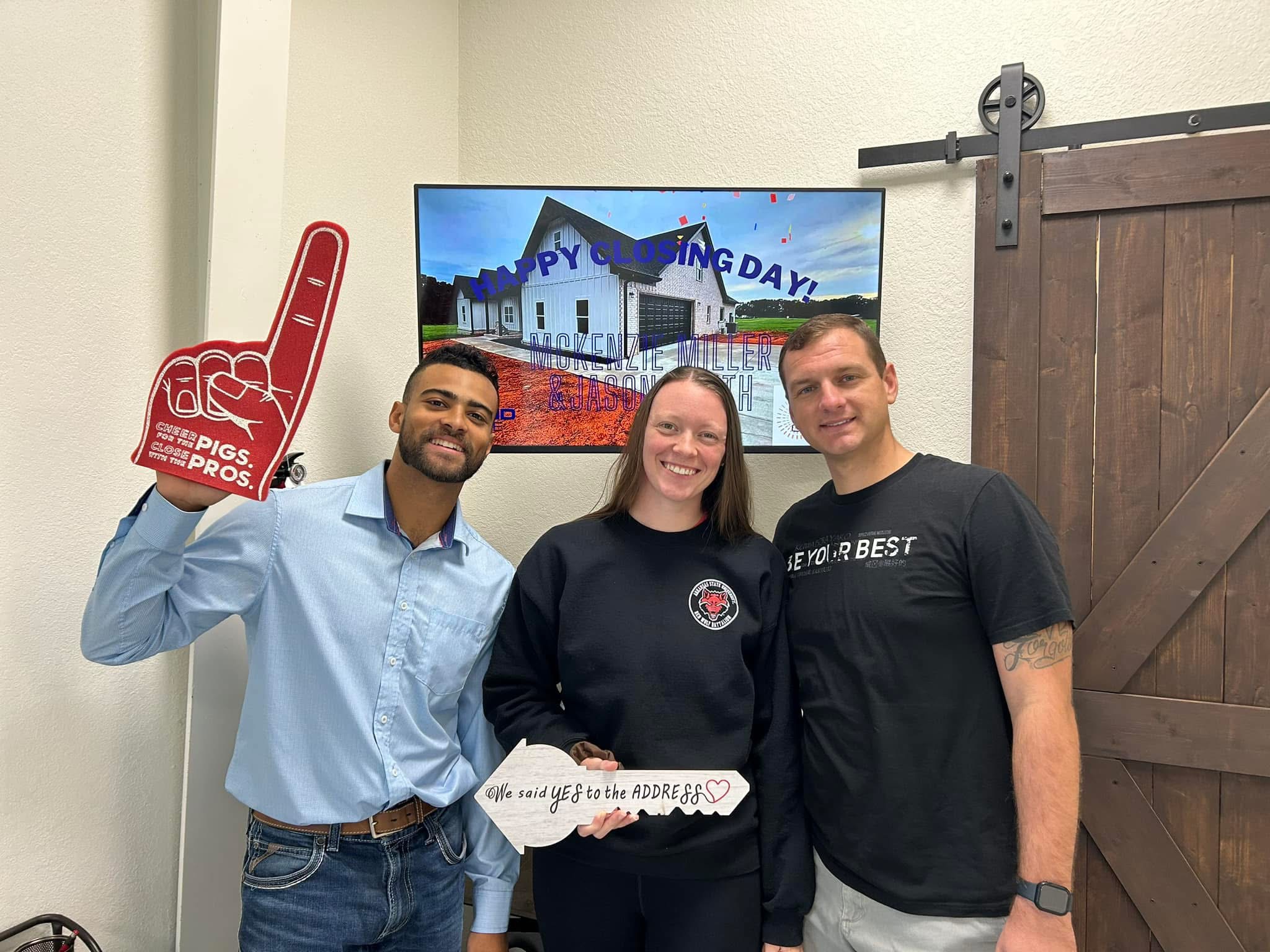 Madison Burke with clients celebrating a new address